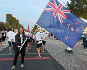 Dunedin athlete Anna Grimaldi carries the flag for the New Zealand team at the Paralympics...