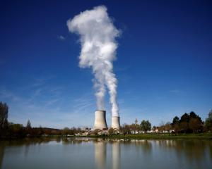 Steam rises from cooling towers of the Electricite de France nuclear power station in Civaux,...