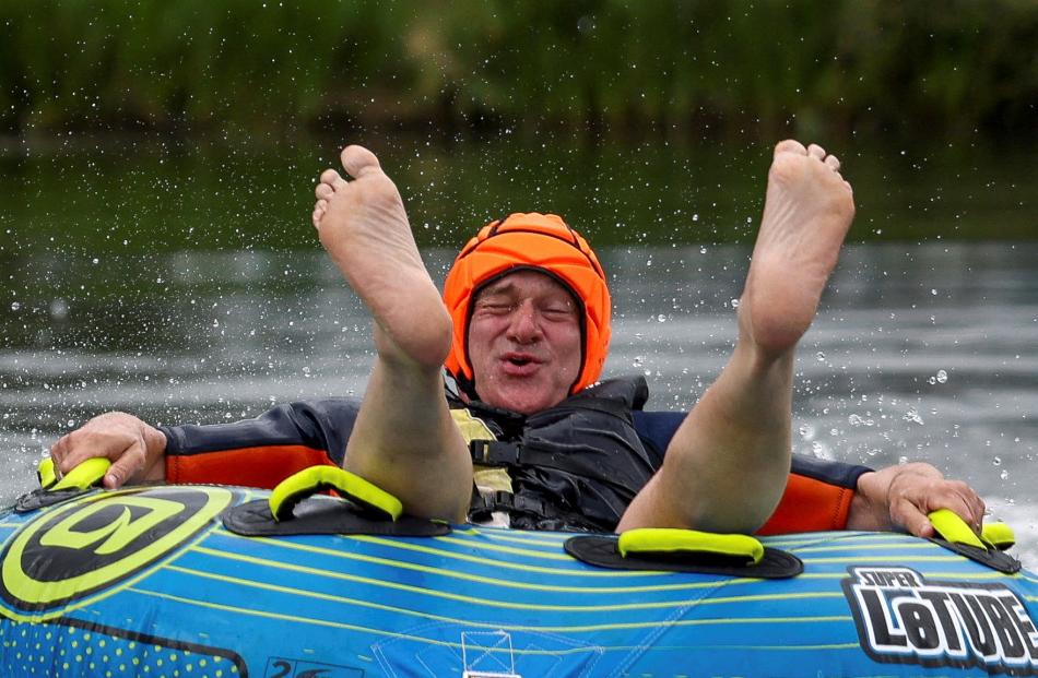 British leader of the Liberal Democrats party Ed Davey rides a towable inflatable during a visit...