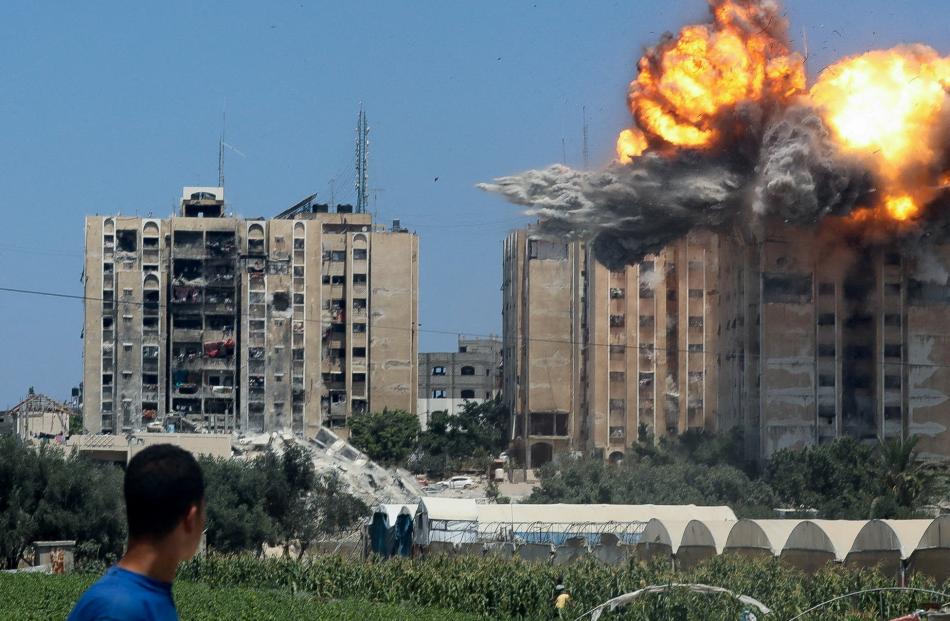 An explosion occurs following an Israeli air strike on a residential building in Nuseirat, Gaza.