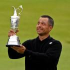 Xander Schauffele celebrates with the Claret Jug trophy after winning the 152nd Open Championship...