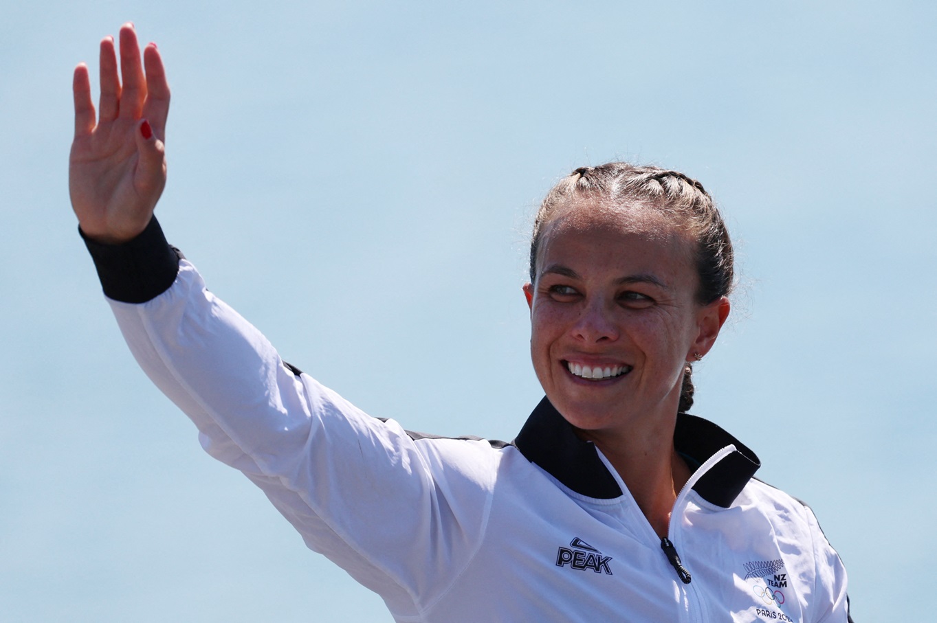 Lisa Carrington celebrates on the podium after her victory. Photo: Reuters