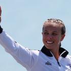 Lisa Carrington celebrates on the podium after her victory. Photo: Reuters