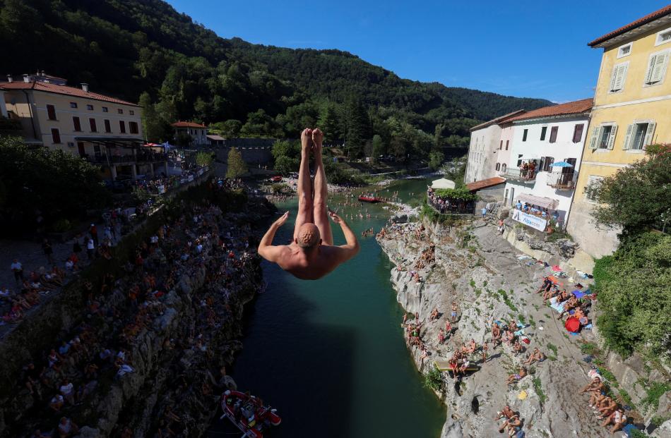 A man jumps from a 17m bridge during a diving exhibition, in Kanal, Slovenia. PHOTOS: REUTERS