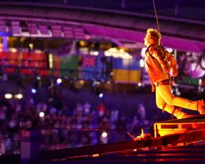 Actor Tom Cruise jumps from the roof of the Stade de France during the closing ceremony. Photo:...