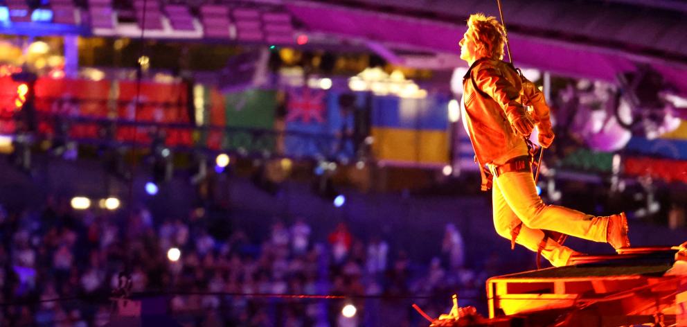 Actor Tom Cruise jumps from the roof of the Stade de France during the closing ceremony. Photo:...