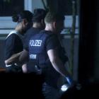 Police officers detain a person, following an incident in which several individuals were killed...