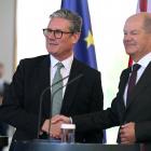 Britain's Prime Minister Keir Starmer (L) and German Chancellor Olaf Scholz shake hands at the...