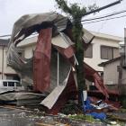 An object blown by strong winds caused by Typhoon Shanshan lies stranded on a power line in...