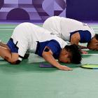 Indonesian badminton players Rina Marlina and Subhan Subhan celebrate after winning their match...