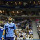 Novak Djokovic looks at a replay between points against Alexei Popyrin (not pictured) in a men's...