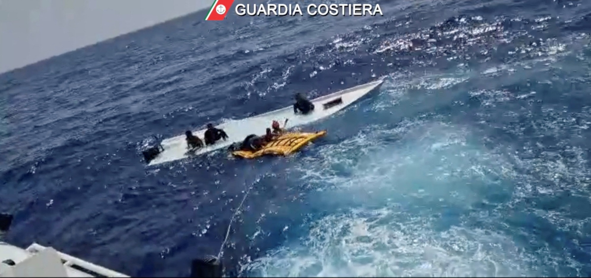 Coastguard members take part in the rescue near the Sicilian island of Lampedusa. Photo: Guardia...