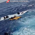 Coastguard members take part in the rescue near the Sicilian island of Lampedusa. Photo: Guardia...