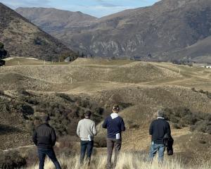 Looking over the proposed new Hogan Gully golf course earlier this year are (from left) course...