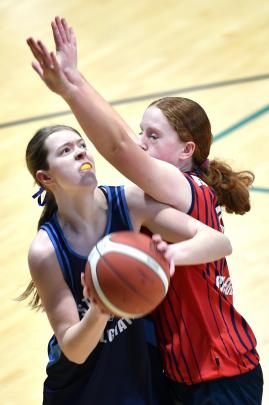 Charlotte Watkins (St Hilda’s Collegiate) looks for a way past Ashburton College defender...