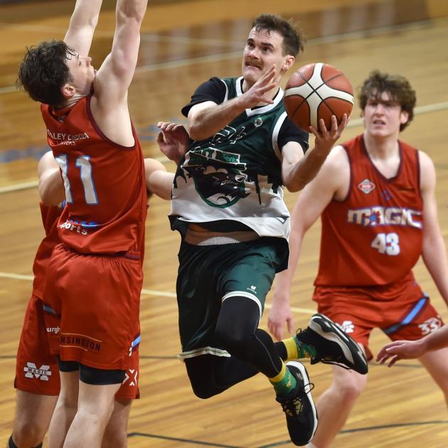 Bombers guard Hamish Robertson tries to get around Lions defenders Noah McDowall (left) and...