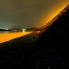 Luminous Nyctiphane krill, in the foreground, decorate the Otago Harbour shore. Photo: Ian Griffin