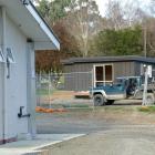 A contractor works on the site of controversial cabins, due to be removed after public outcry, at...