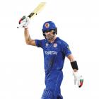 Afghanistan opener Rahmanullah Gurbaz raises his bat after scoring a half-century during his team...