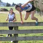 Queens runner Kotomiyo Cowell, 15, jumps a fence.


