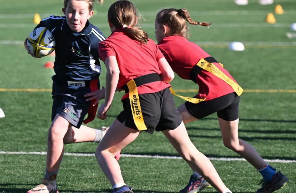 Heidi Campbell, 10, of Elm Grove School looks to duck past the Palmerston School defenders.