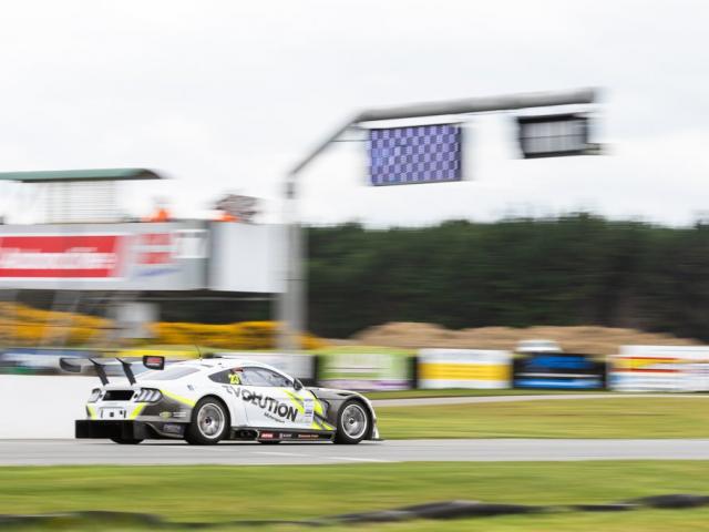 Jordan Michels, of Invercargill, takes the  chequered  flag in his Marc Ford Mustang in the class...