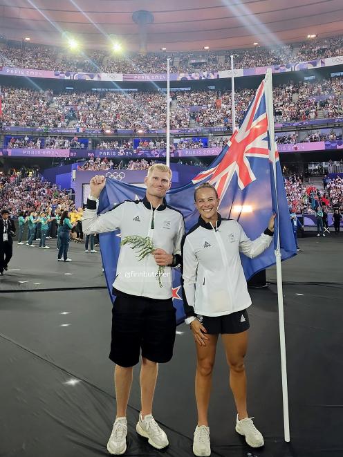 Finn Butcher and Dame Lisa Carrington fly the flag for the New Zealand team in Stade de France at...