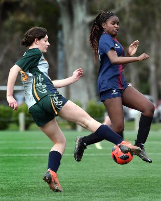 Autumn Flanagan (Bayfield High School, left) tussles with Esther Koudayah, of Trinity Catholic...