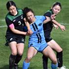 Royals midfielder Shontelle Smith battles for the ball with Western Spring players Tiana Hill ...