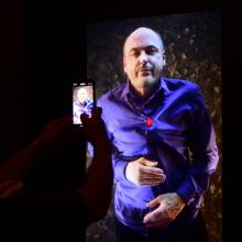 A visitor admires American artist Bill Viola's self portrait at the Artist's Selfportraits Hall...