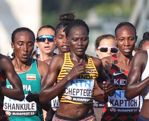 Uganda's Rebecca Cheptegei, centre, competes in the women's marathon final during the World...