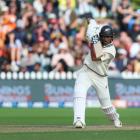 New Zealand’s Rachin Ravindra dispatches a drive on day three of the first test against Australia...