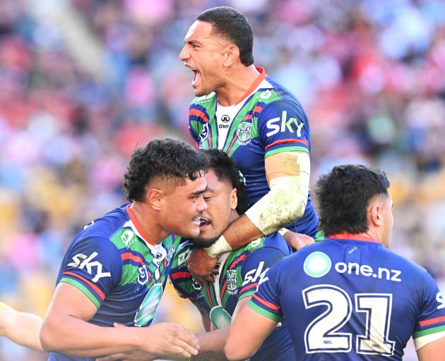 Warriors players celebrate scoring a try during the NRL Round 11 match between the New Zealand...