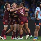 Queensland celebrate a try on a dismal night for Blues fans in Sydney. Photo: Getty Images