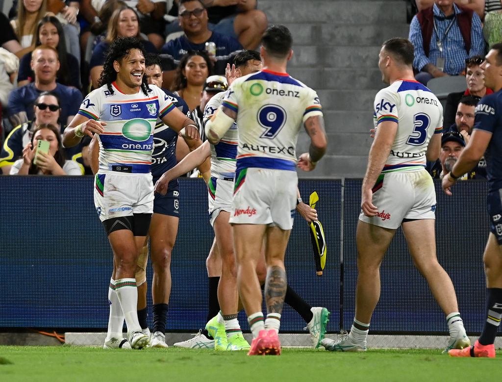 The Warriors' Dallin Watene-Zelezniak (L) celebrates after scoring a try against the Cowboys....