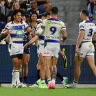 The Warriors' Dallin Watene-Zelezniak (L) celebrates after scoring a try against the Cowboys....