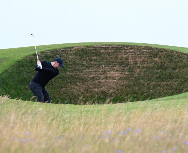 Rory McIlroy attempts a shot out of one of Royal Troon's cavernous bunkers. Photo: Getty Images