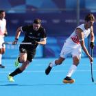 Antoine Kina of Team Belgium runs with the ball whilst under pressure from Hayden Phillips of...