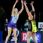 Carys Stythe of the Northern Mystics (left) competes against Central Pulse's Tiana Metuarau at a...