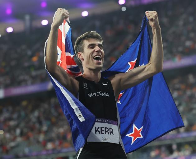 Hamish Kerr celebrates winning the Paris Olympics men’s high jump final at Stade de France in...