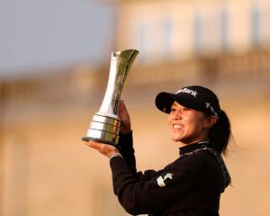 Lydia Ko poses with the trophy following her victory in the Women's British Open. Photo: Getty