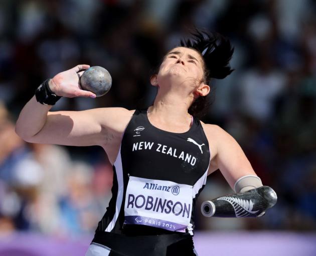 Holly Robinson strives for distance in the F46 shot put final at the Paralympics in Paris. PHOTOS...