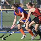 Mary Flatman (left) tries to get something going for the City Highlanders despite attention from...