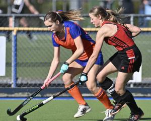 Mary Flatman (left) tries to get something going for the City Highlanders despite attention from...