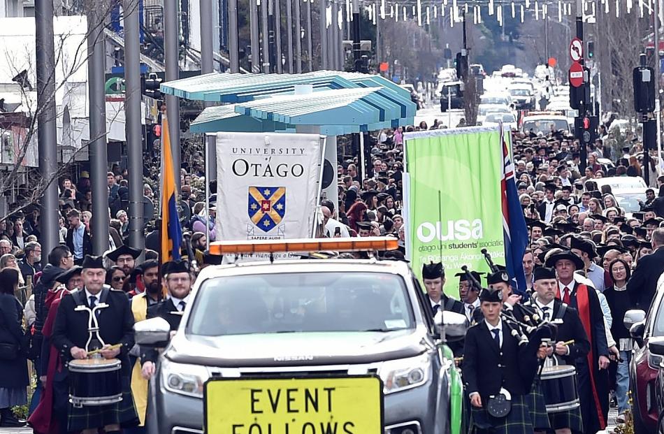 University of Otago graduands are escorted by a  police car for the first graduation ceremony in...