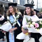 Elizabeth Howard (left) and Kaia Pola were part of the graduands' procession.