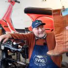 Mornington shoe repair shop Country Cobbler owner Greg Fox holding the shoes of an old customer,...