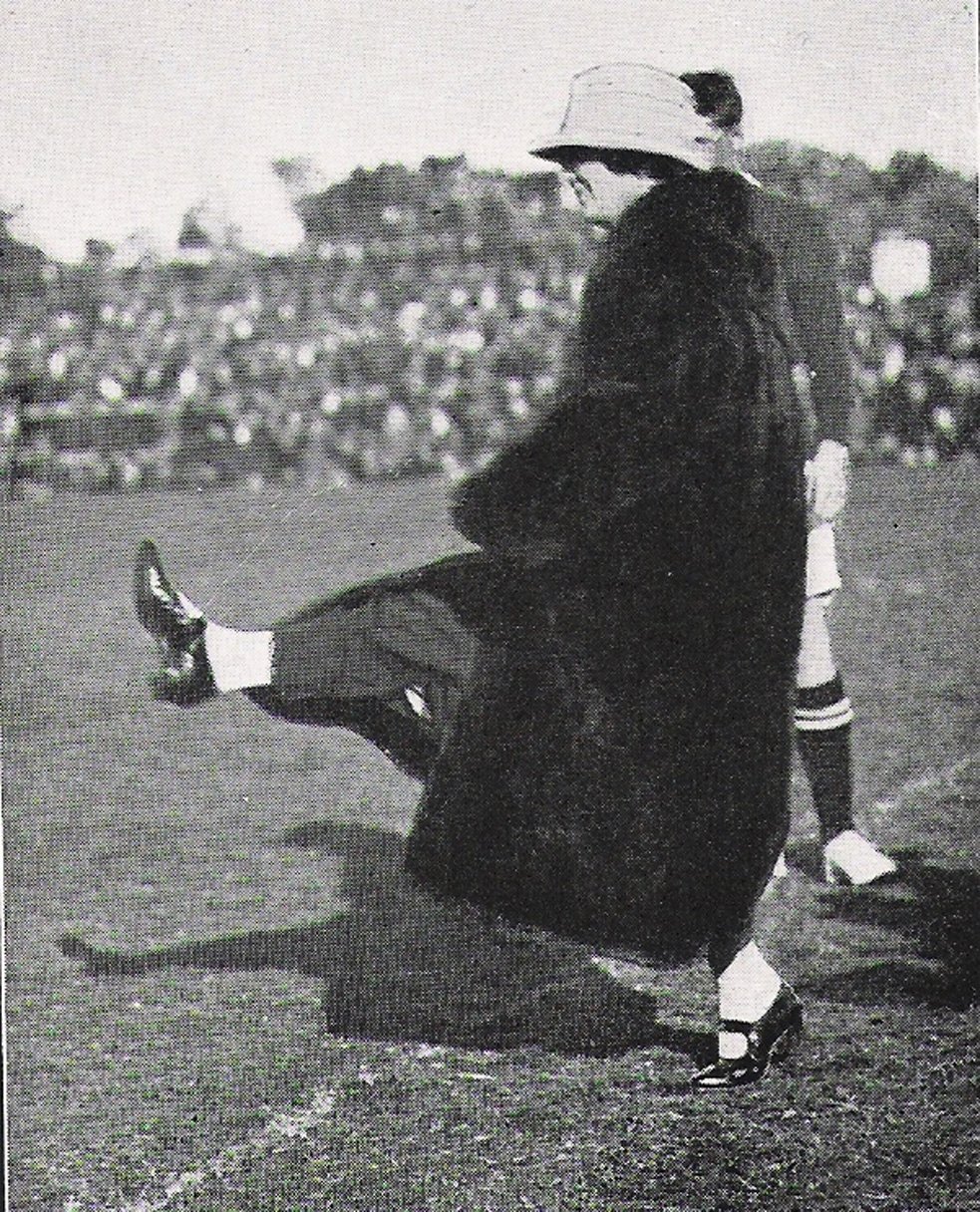 Mrs Harold Tapley, the wife of the Dunedin Mayor, does an honorary kick-off in her fur coat.