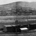 The wooden frame of the first block of the exhibition buildings at Logan Park dwarfs stacks of...