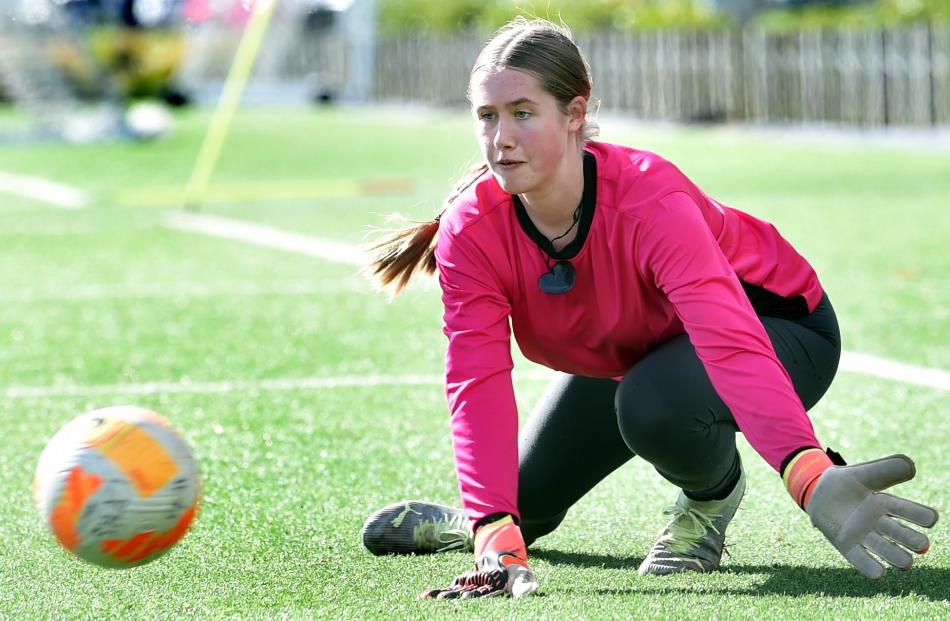 Logan Park High School goalkeeper Maia Hamilton warms up for a football game.